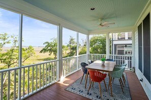 Outdoor dining - The Hidden Palm: Luxurious 5-Bed Home, Screened Porches, Game Room & Marsh Views! (Fripp Island)