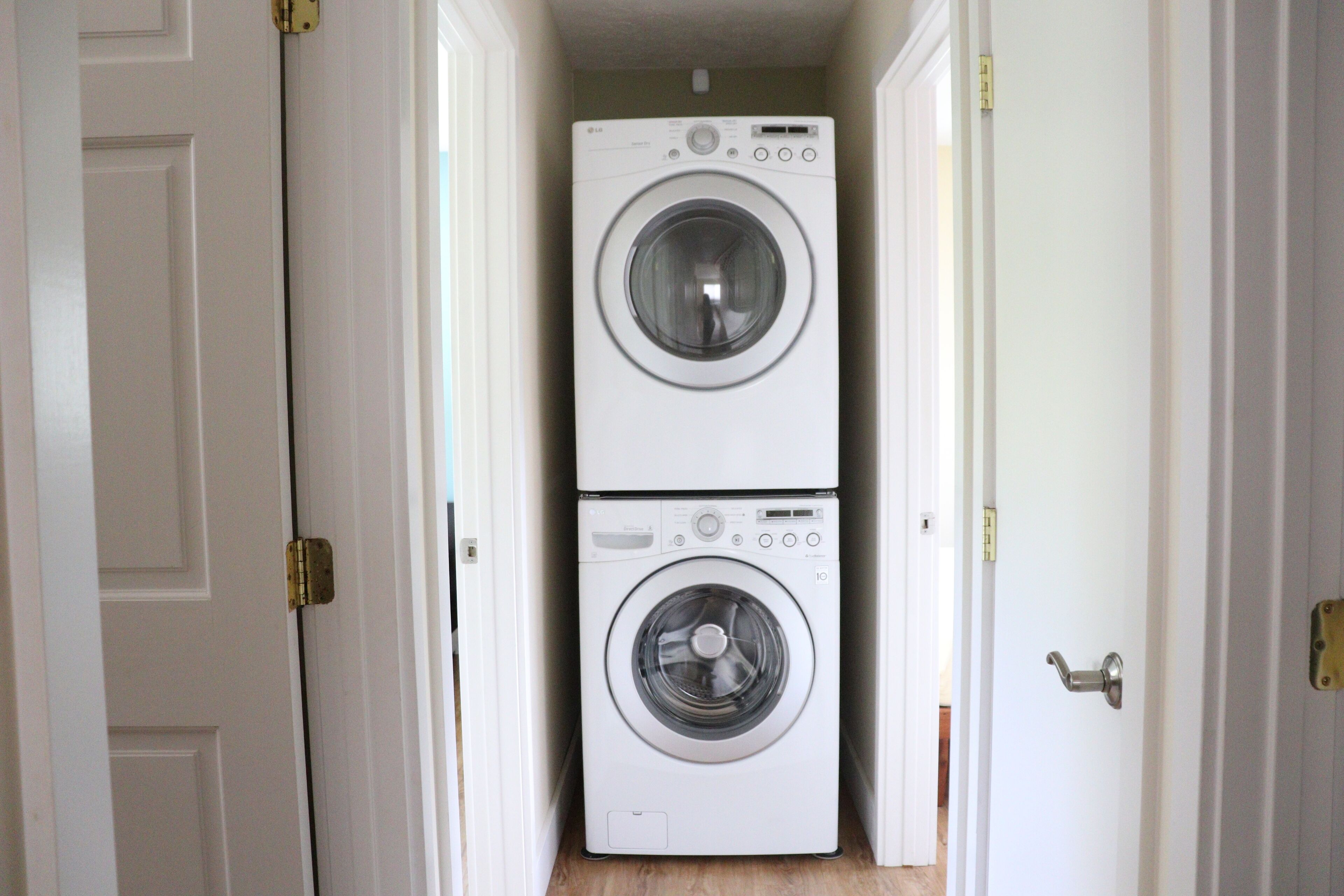 A laundry room with two stacked front-loading washing machines.