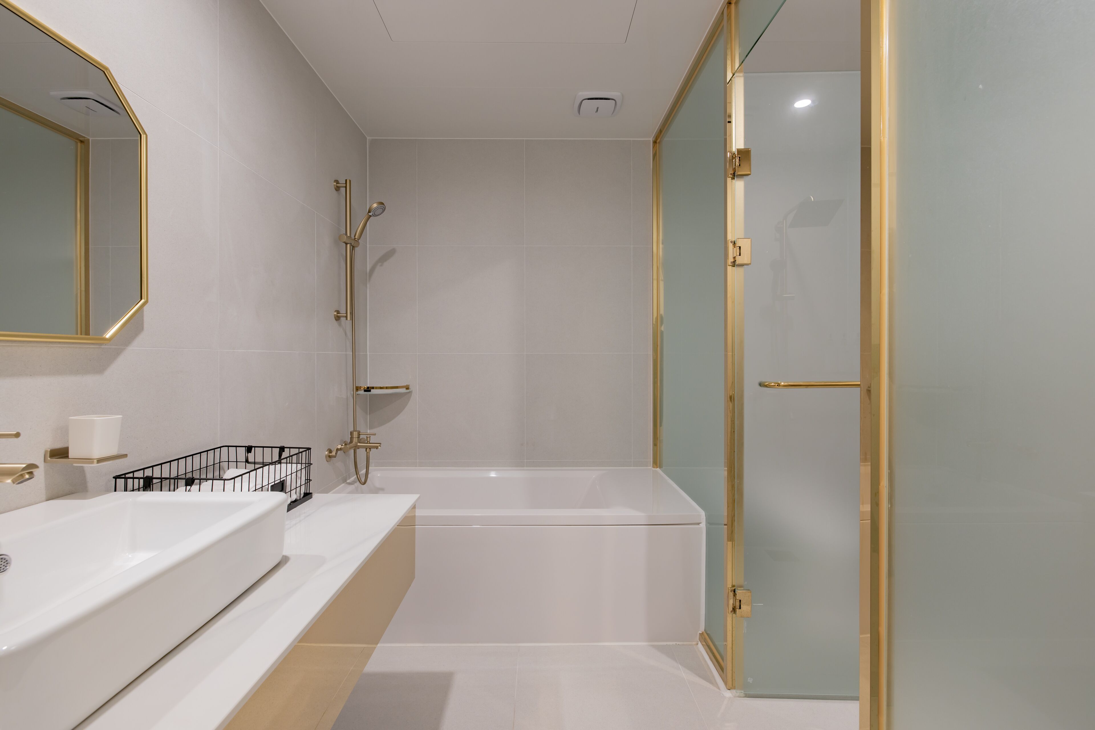 A modern bathroom with a large bathtub, a separate shower area, and a glass-enclosed walk-in shower.