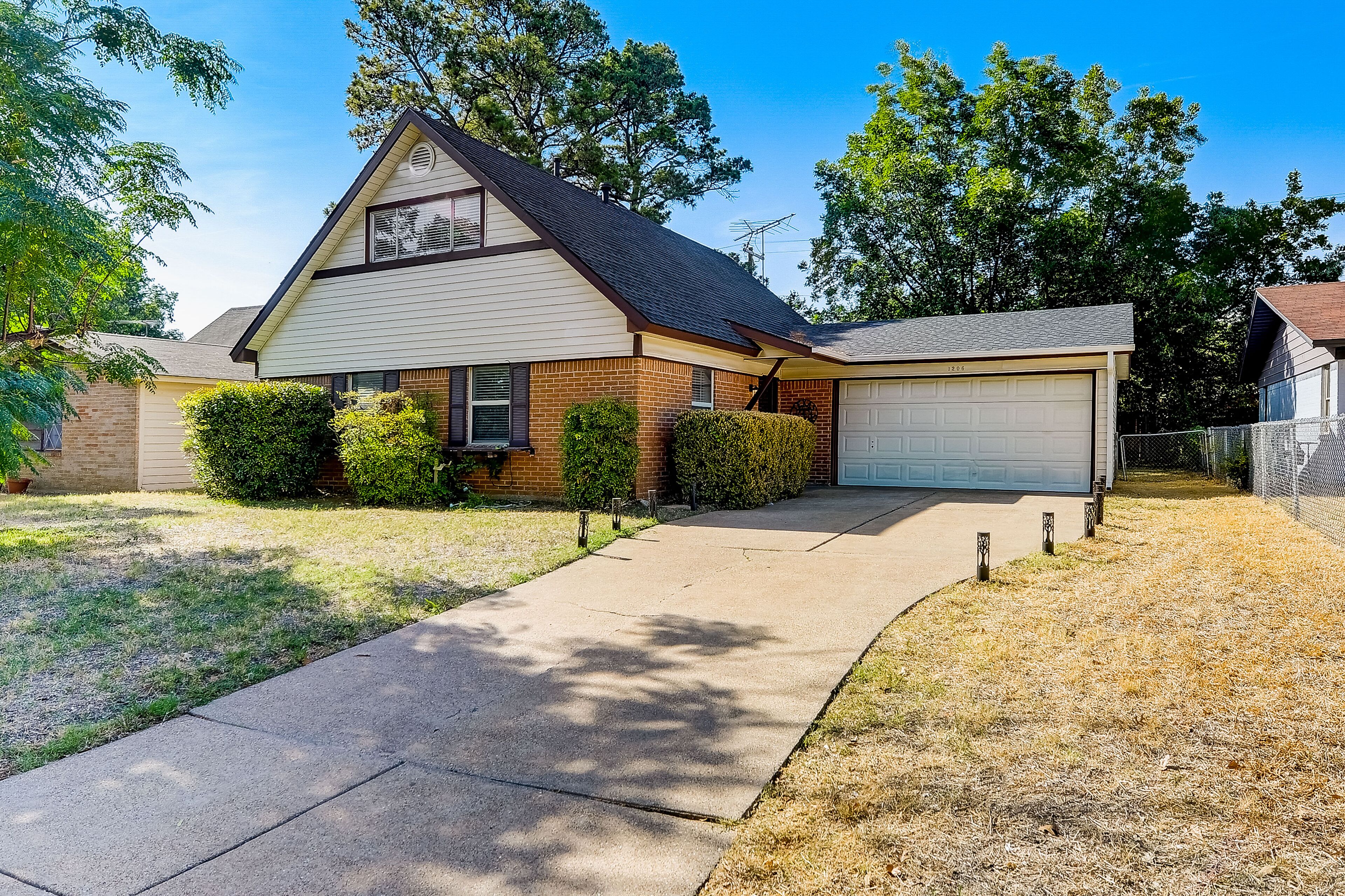 Two-story, dog-friendly home with a fenced yard, furnished patio, & central AC