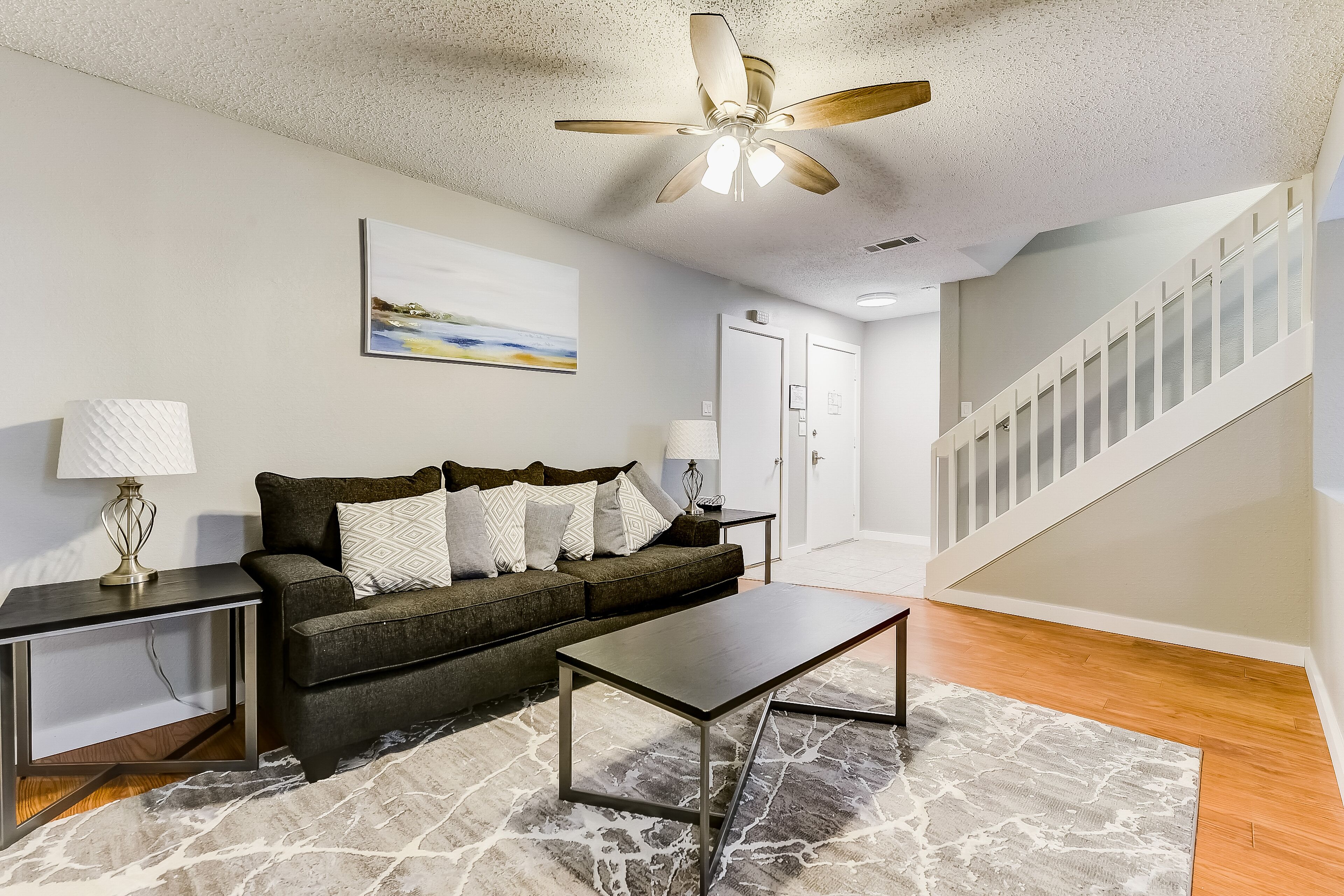 Two-story, dog-friendly home with a fenced yard, furnished patio, & central AC