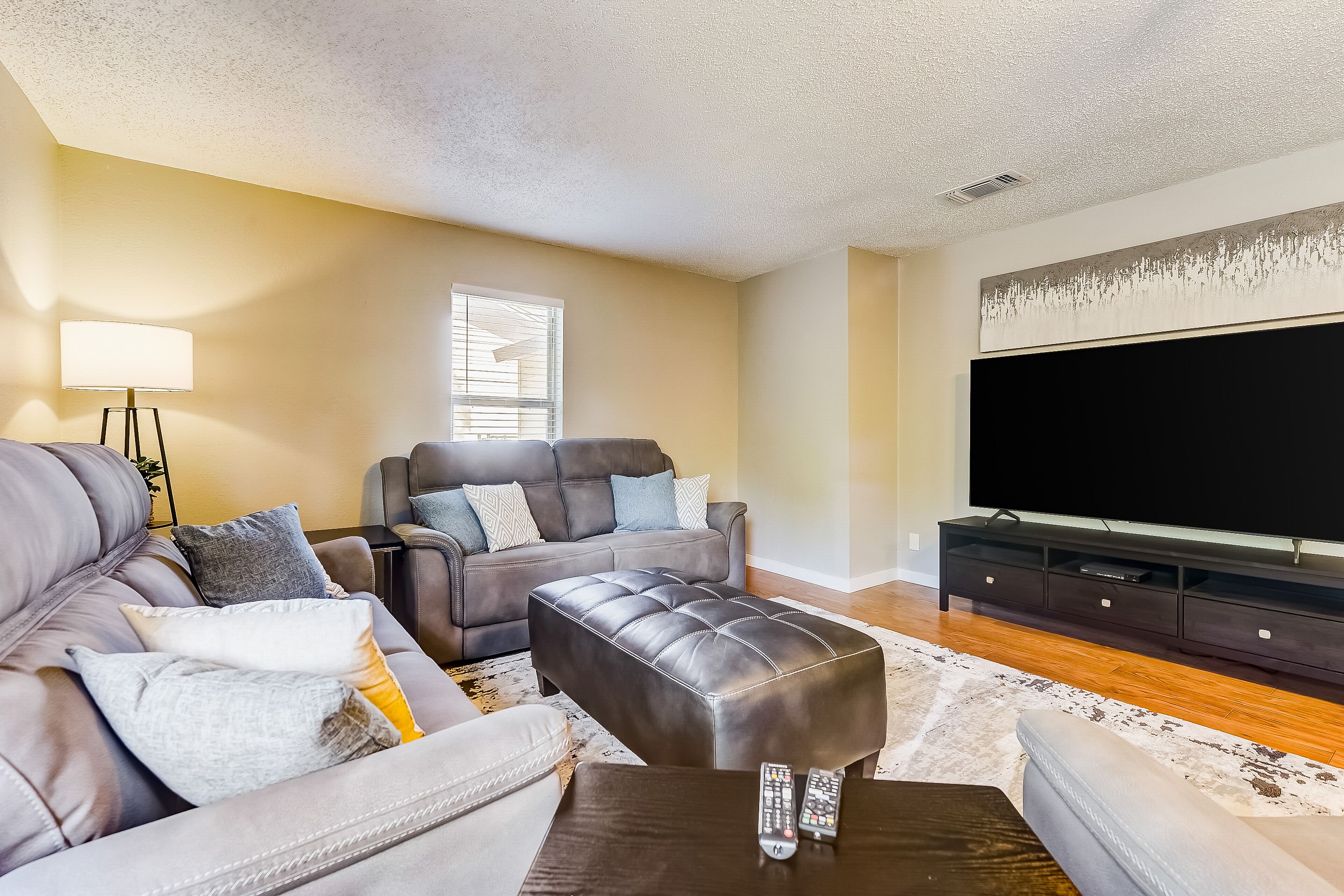 Two-story, dog-friendly home with a fenced yard, furnished patio, & central AC