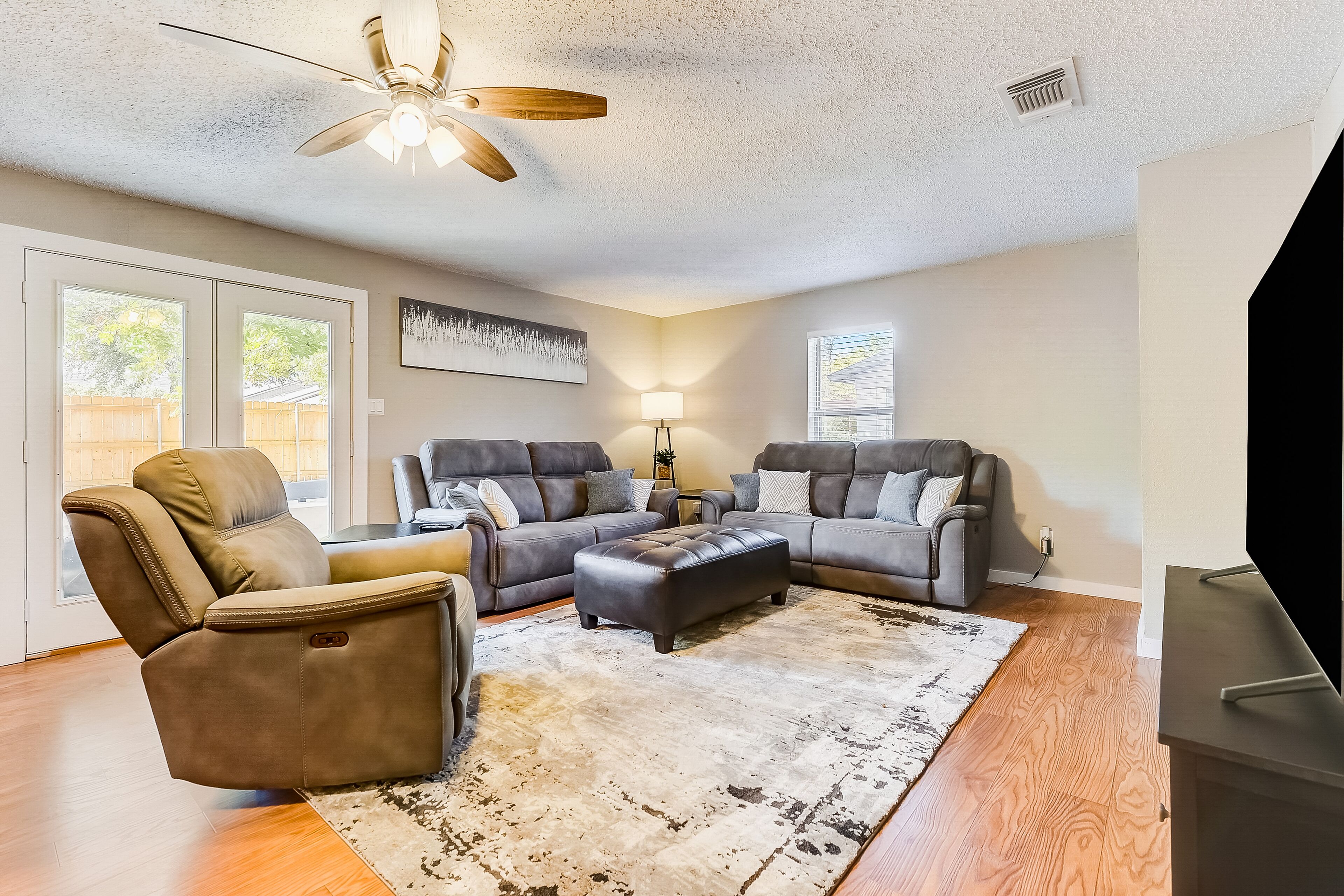 Two-story, dog-friendly home with a fenced yard, furnished patio, & central AC