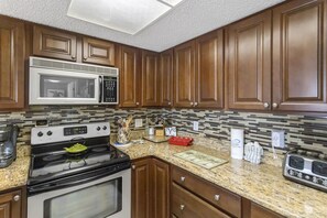 Enjoy cooking in this well-equipped kitchen with a microwave, stove, toaster, and coffee maker.