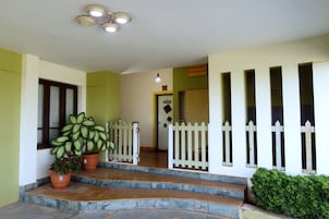 A staircase leading to a door with a white picket fence.