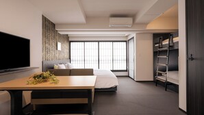 A modern hotel room with a bed, a sofa, a desk, and a TV. - MIMARU Osaka Shinsaibashi North (Osaka)