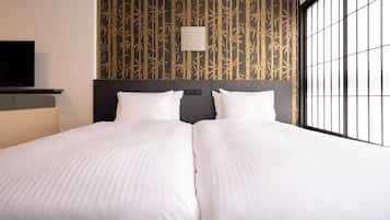 A double bed with white linens, a headboard with a control panel, and a wall with a bamboo pattern.
