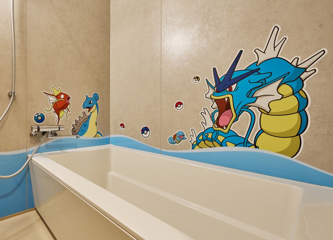 A bathroom with a bathtub featuring cartoon characters and stickers.