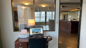 A hotel room with a desk, chair, lamp, and a large mirror reflecting the room. - Super 8 By Wyndham Sterling CO (Sterling)