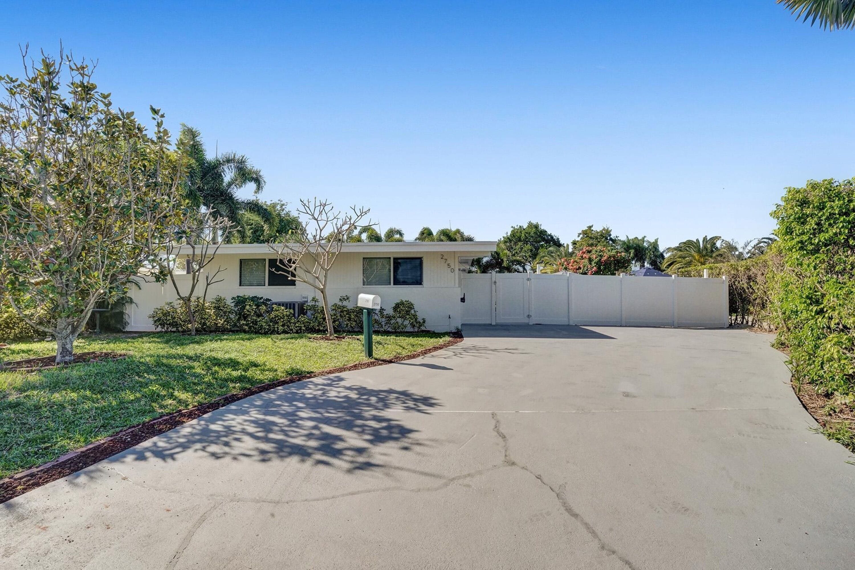 A single-story house with a driveway leading to a garage.