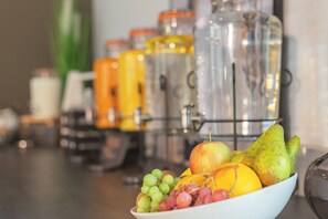 A bowl of fruit on a counter with jars in the background. - Candlewood Suites Augsburg by IHG (Gersthofen)
