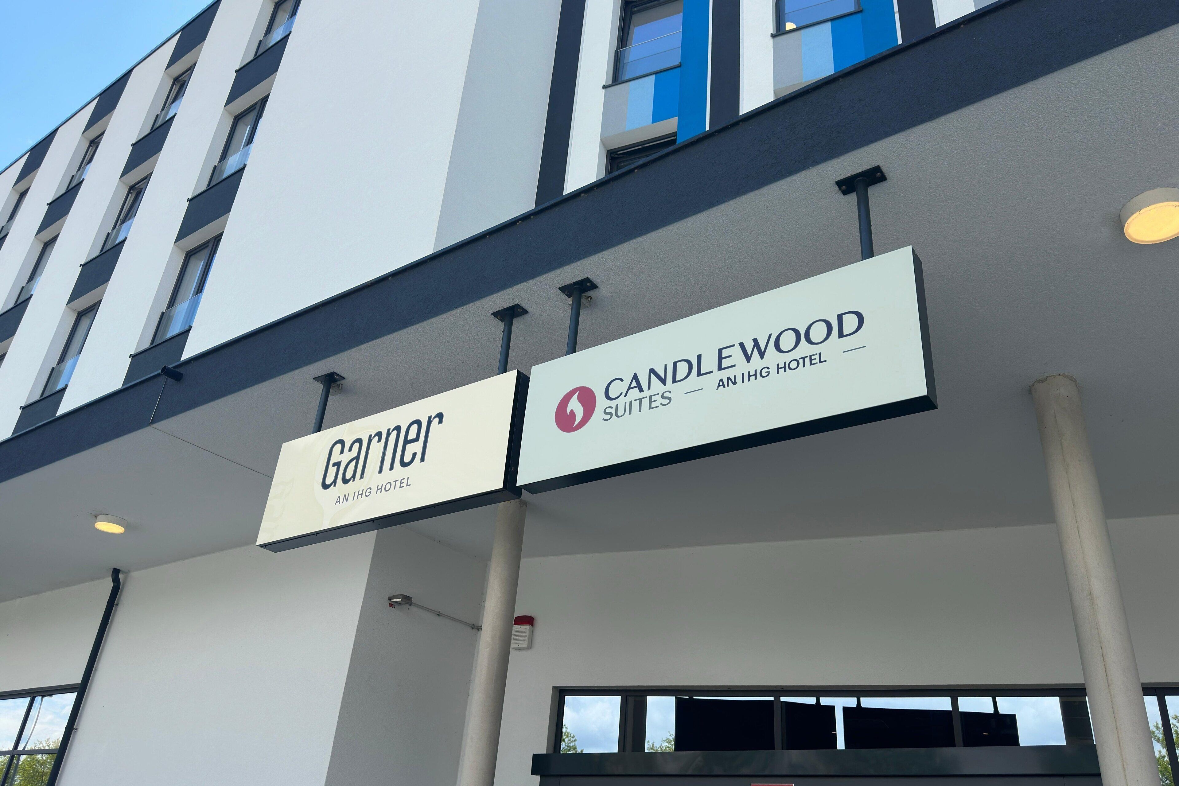 A hotel sign with "Garnier" and "Candlewood Suites" indicating the hotel name and type.