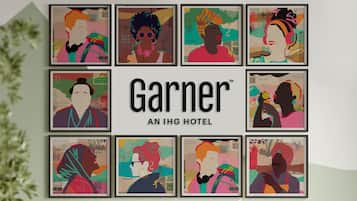 A series of framed artworks with the text "Garner AN IHG HOTEL" in the center, indicating the hotel's branding.