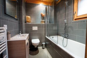 Bathtub, hair dryer, towels, soap
