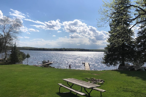 Hundreds of feet of lake frontage with a picnic table and fire pit for each cabin
