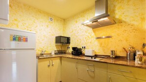 Une cuisine équipée d’un four à micro-ondes, d’un grille-pain et d’un évier.
