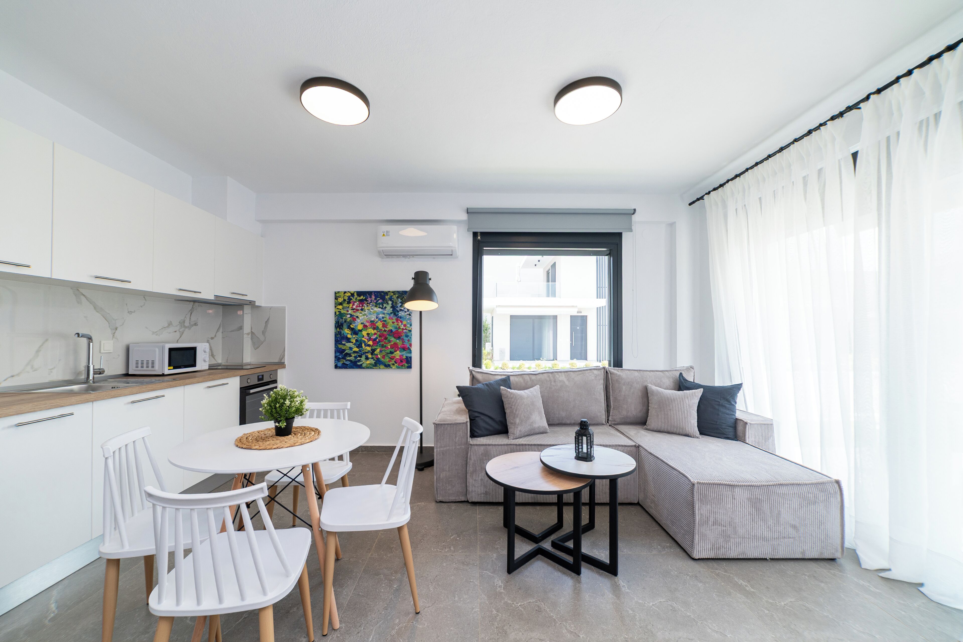 A modern apartment with a kitchen, dining area, and living room.