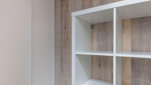 A white shelving unit against a wooden wall. - Les Lauzes D25 by Interhome (Les Menuires)
