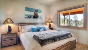 A bedroom with a wooden bed, white bedding, a large window with a view of trees, and two bedside lamps. - Luxury Home on 8 Acres - Fantastic Views and outdoor space - 20 Min to DGO (Durango)