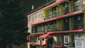 A multi-story building with balconies, a staircase, and a sign for Snow Crest Lodges. - Snow Crest Lodges (Mekhtar)