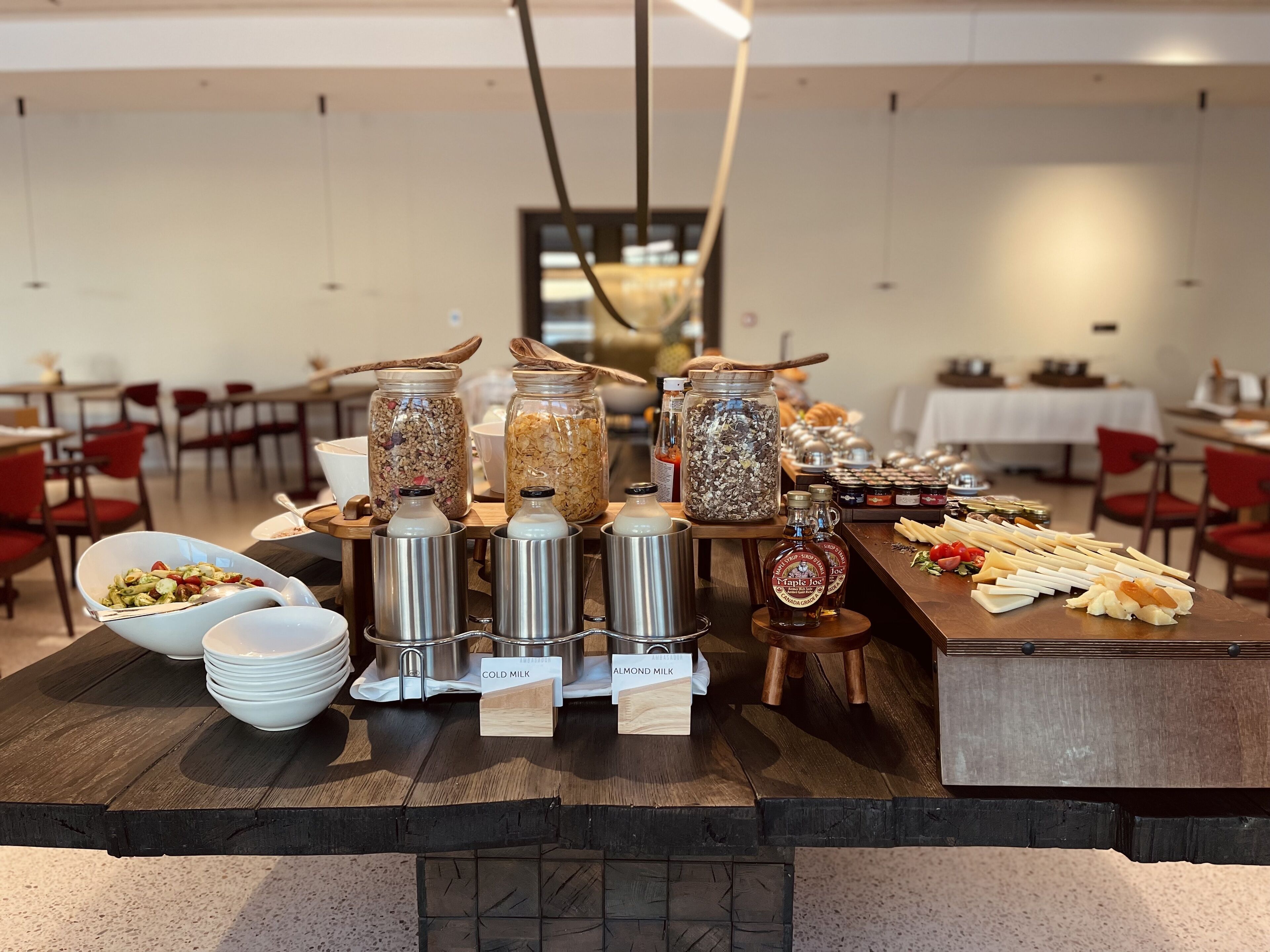 A buffet setup with various food items and condiments.