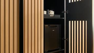 A modern wardrobe with a combination of vertical wooden slats and a black door.
