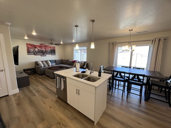 A modern apartment with a kitchen, dining area, and living room.