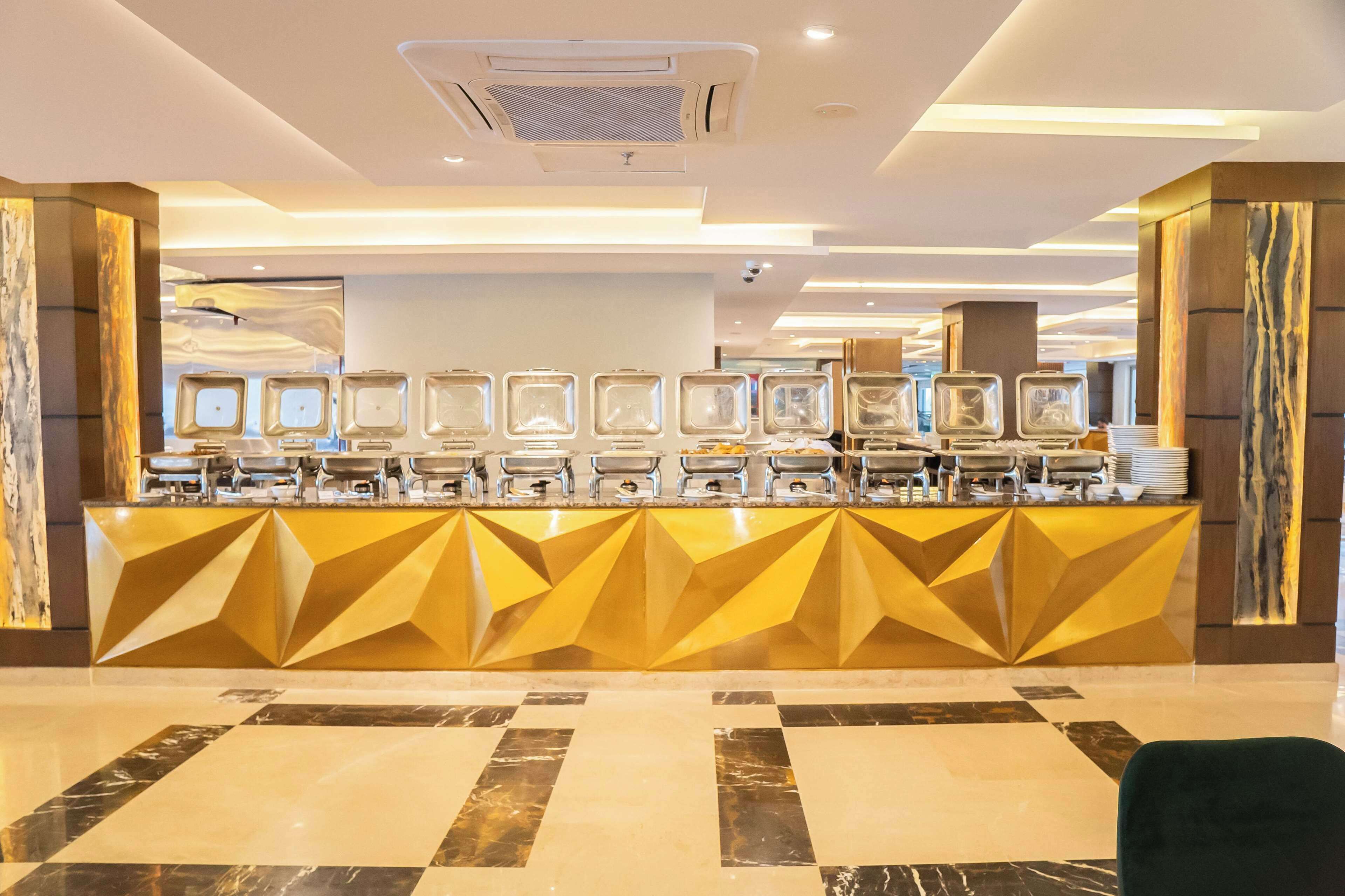 A reception area with a modern design, featuring a geometric patterned counter and a marble-tiled floor.