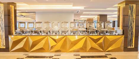 A reception area with a modern design, featuring a geometric patterned counter and a marble-tiled floor.