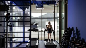 A gym with treadmills, weights, and a large window overlooking a street. - Adagio Access Gent Centrum Dampoort (Ghent)