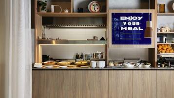 A kitchen area with wooden shelves, a blue sign, and various kitchen items.