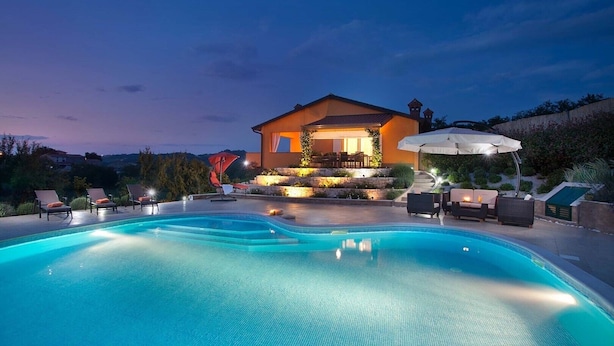 A modern house with a swimming pool, outdoor seating, and a well-lit patio area. - Large outdoor with privacy, Heated pool 60m2 , Gamesroom ,Wellness, Garden (Karojba)