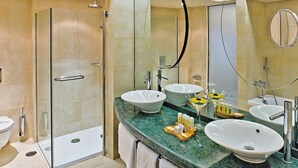 A modern bathroom with a glass-enclosed shower, a marble countertop, multiple sinks, and a large mirror. - Luxurious 1 Bedroom Royal Suite (Dominican Republic)