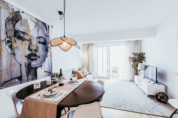 Enjoy a meal in this stylish dining area with a large abstract painting and comfortable seating.