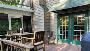 A wooden deck with a table and chairs, a green door, and a railing. - NEW!Lakefront retreat with huge dock, private cove. Perfect for Clemson Football (Central)