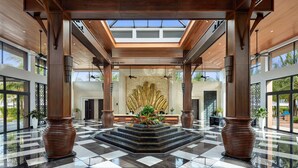A spacious lobby with a checkered floor, a central fountain, and a large wall mural. - Best Western Premier Sonasea Villas Phu Quoc (Phu Quoc)