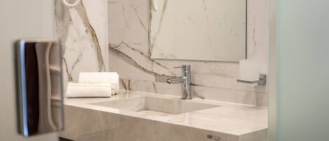 A bathroom with two sinks, a mirror, and a towel rack.