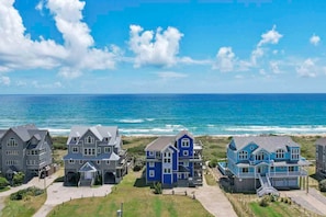 A coastal residential area with houses directly adjacent to the ocean.