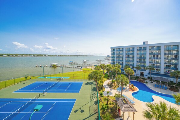 A hotel with a tennis court, pool, and waterfront view. - Gulf Shores Surf and Racquet Club 502B - 2 Bed Condo (Gulf Shores)