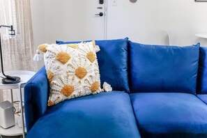 Relax in this stylish living room with a comfortable sofa, decorative pillow, and floor lamp.