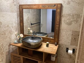 A bathroom with a stone sink, wooden vanity, and a mirror with a wooden frame. - Alamanda 4 guests, pool, direct access to beach (Saint Paul)