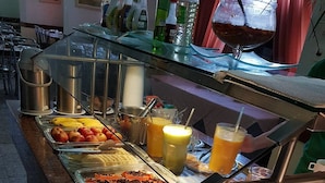A buffet with various fruits, juices, and beverages. - Hotel Atlântico Tower - SOFT OPENING (Rio de Janeiro)