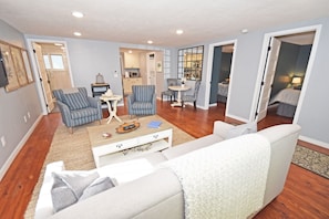 Relax in this inviting living room with a comfortable sofa, armchairs, and a coffee table.