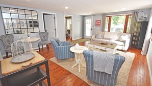 A living room with a sofa, two armchairs, a coffee table, and a side table. - Charming, Updated Home in the Heart of Downtown Glen Arbor!  (Glen Arbor)