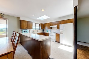 Una cocina moderna con armarios de madera, una isla central y electrodomésticos integrados.