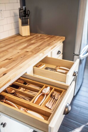 Fridge, dishwasher, coffee/tea maker, cookware/dishes/utensils