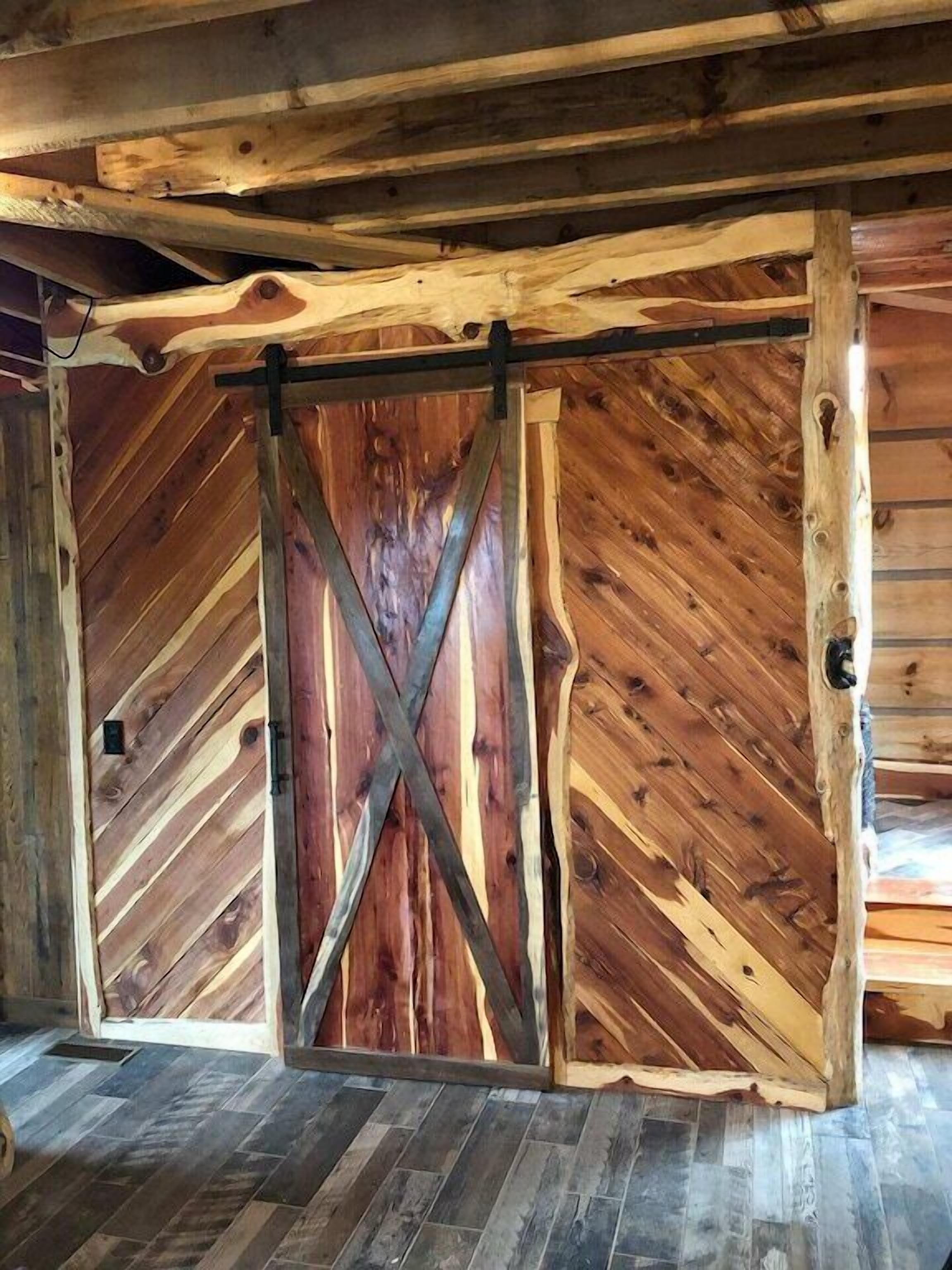 A rustic barn-style interior with wooden walls and a herringbone floor pattern.