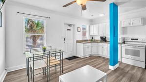 A modern kitchen with white cabinets, a granite countertop, and a built-in oven.