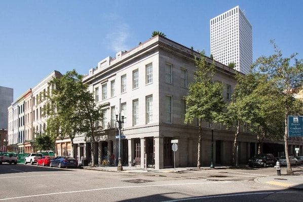 A historic building with a classic facade, large windows, and a flat roof.