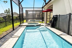 A swimming pool with a hot tub, surrounded by a covered patio area with a red umbrella. - SpecialOffer-7BR with PrivatePool/GameRoom1859TPC (Four Corners)